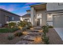 Beautiful home featuring stone steps leading to the front door with manicured landscaping at 2647 Hourglass Dr, Henderson, NV 89052