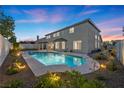 Inviting backyard oasis with a sparkling pool and lush landscaping at 2647 Hourglass Dr, Henderson, NV 89052