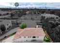 Elevated view of a cozy home and its backyard with the Las Vegas Strip in the background under a partially cloudy sky at 2679 Regency Cove Ct, Las Vegas, NV 89121