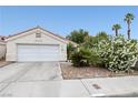 Charming single-story home with a two-car garage, desert landscaping, and traditional-style roofline at 2837 Du Barry Manor Ln, Las Vegas, NV 89108