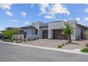 Attractive modern home with desert landscaping and a convenient three-car garage at 313 Forsyth Park St, Las Vegas, NV 89138