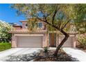Charming two-story home featuring a tile roof, stone accents, and a two-car garage at 3408 Livia Ave, North Las Vegas, NV 89031