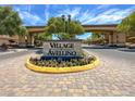 Beautifully landscaped entrance to Village of Avellino with decorative brickwork and signage at 3638 Via Messina, Henderson, NV 89052