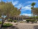 Picturesque community pool area with a flag pole, trees and lounge area at 3638 Via Messina, Henderson, NV 89052
