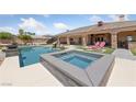 Beautiful backyard featuring a pool, hot tub, and covered patio with outdoor seating at 3955 W Jo Rae Ave, Las Vegas, NV 89141