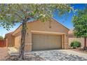 Single-story home showcasing desert landscaping, a two-car garage and covered entry for curb appeal at 4037 Vulcan St, Las Vegas, NV 89122
