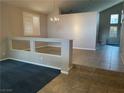 Bright and airy living room featuring tile and carpet flooring, neutral colors, and natural light at 4121 Erinbird Ave, North Las Vegas, NV 89084