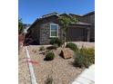 Beautiful single-Gathering home with desert landscaping, stone accents, and a paved driveway at 4376 Latitude Valley Ct, North Las Vegas, NV 89084