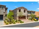 Inviting home displays desert landscaping, paved driveway leading to a two-car garage, and a clear blue sky at 44 Moon Hill Dr, Henderson, NV 89011