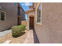 This home showcases a welcoming front entry with a stylish walkway and beautiful desert landscaping at 44 Moon Hill Dr, Henderson, NV 89011