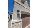 Exterior close-up showcasing a stylish outdoor lantern mounted near the garage entrance at 44 Moon Hill Dr, Henderson, NV 89011