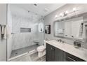The updated bathroom features a marble tile shower, modern vanity, and a sleek frameless glass door at 5018 S Rainbow Blvd # 202, Las Vegas, NV 89118