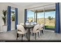 Bright dining area with patio access, modern furnishings, and stylish decor for a comfortable dining experience at 516 Hamilton Dr # Lot 25, Mesquite, NV 89027