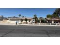 Single-story home featuring mature trees, a well-maintained front yard, and inviting curb appeal at 5170 S Pearl St, Las Vegas, NV 89120
