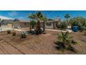 Single-story home featuring desert landscaping and mature palm trees at 5170 S Pearl St, Las Vegas, NV 89120