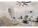 Bright living room with modern decor, wood floors and a staircase at 529 Fork Mesa Ct, Henderson, NV 89015