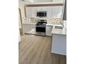 Modern kitchen with stainless steel appliances, ample counter space, and sleek cabinetry at 5512 Del Lago Dr, Las Vegas, NV 89130