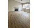 Spacious living room featuring sleek flooring, fireplace, and ample natural light at 5512 Del Lago Dr, Las Vegas, NV 89130