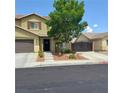 Charming two-story home featuring a neutral palette, well-kept lawn and convenient attached two-car garage at 5516 Coyote Falls Ct, Las Vegas, NV 89131