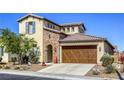 Beautiful two-story home with brick accents, a two-car garage, and desert landscaping at 5650 Pleasant Palms St, North Las Vegas, NV 89081