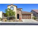 Beautiful two-story home with brick accents, a two-car garage, and low-maintenance desert landscaping at 5650 Pleasant Palms St, North Las Vegas, NV 89081