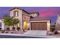 Charming two-story home with a brick-accented entrance and landscaped front yard at 5650 Pleasant Palms St, North Las Vegas, NV 89081