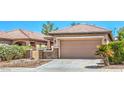 Charming home with a two-car garage, desert landscaping, and a private gated courtyard at 5960 Wheat Penny Ave, Las Vegas, NV 89122