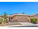 Inviting single-story home with a desert landscape, tile roof, and a convenient two-car garage at 5960 Wheat Penny Ave, Las Vegas, NV 89122