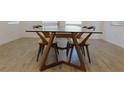 Modern dining table with a glass top and unique wooden chairs at 6250 Lamont Hills Ave, Las Vegas, NV 89139