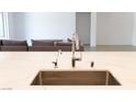 Close-up of a stylish kitchen island featuring a sink and modern fixtures at 6250 Lamont Hills Ave, Las Vegas, NV 89139
