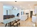 Bright open-concept living space with modern lighting, dining area, and well-appointed kitchen at 6250 Lamont Hills Ave, Las Vegas, NV 89139