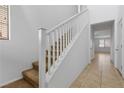 Interior staircase featuring carpeted steps and a white railing at 6354 Point Isabel Way, Las Vegas, NV 89122