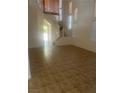 Bright living room featuring tile flooring, high ceilings, and stairway with natural light at 7228 Chic Ave, Las Vegas, NV 89129