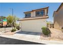 Charming two-story home featuring a two-car garage and neutral-toned stucco exterior at 795 Kiska Ave, Las Vegas, NV 89123