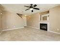 Spacious living room featuring tile floors, a ceiling fan, and a modern fireplace at 795 Kiska Ave, Las Vegas, NV 89123
