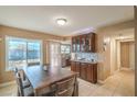 Bright dining area with a view of the front yard and modern furnishings at 824 Schooner Dr, Henderson, NV 89015