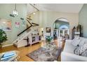 Bright living room with high ceilings, hardwood floors, and a staircase at 8388 Brad Oaks Cir, Las Vegas, NV 89123