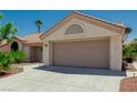 Charming single-story home featuring a desert landscape and a two-car garage at 8921 Signal Terrace Dr, Las Vegas, NV 89134