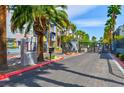 Gated entrance with mature palm trees and landscaping at 9050 W Tropicana Ave # 1075, Las Vegas, NV 89147