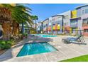 A pool and spa with lounge seating offer a perfect oasis outside the colorful townhomes at 9050 W Tropicana Ave # 1075, Las Vegas, NV 89147