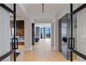 Bright hallway with herringbone floors leads to living area with beautiful city views at 9101 Alta Dr # 1604, Las Vegas, NV 89145