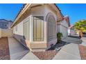 A single story house with a large bay window, desert landscaping and an attached two-car garage at 9398 Sailing Water Ave, Las Vegas, NV 89147