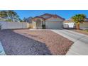 Single-story home featuring a two-car garage and low-maintenance desert landscaping at 9398 Sailing Water Ave, Las Vegas, NV 89147