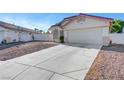 Single-story home with a long driveway, two-car garage, and low-maintenance desert landscaping at 9398 Sailing Water Ave, Las Vegas, NV 89147