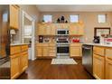 Bright kitchen boasts stainless steel appliances, light wood cabinets, and sleek countertops at 9525 Salem Hills Ct, Las Vegas, NV 89134