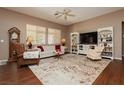 Inviting living room with neutral walls, ceiling fan, and wood laminate flooring at 9525 Salem Hills Ct, Las Vegas, NV 89134