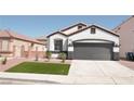Charming single-story home featuring a manicured lawn and a two-car garage at 9604 Flying Eagle Ln, Las Vegas, NV 89123