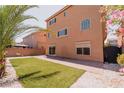 A manicured backyard features a grass lawn, bordered by decorative rock and a brick-paved area at 9728 Panther Hollow St, Las Vegas, NV 89141