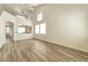 Expansive living room with vaulted ceiling, wood-look floors, and a view to the second story at 9748 Derbyhill Cir, Las Vegas, NV 89117