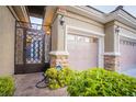 Gated entrance leading to a garage and front door at 10391 Avebury Manor Ln, Las Vegas, NV 89135